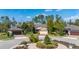 Street view featuring a home with a three-car garage and circular drive with manicured landscaping at 513 San Sebastian Ct, Davenport, FL 33837