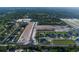 Aerial view of a suburban construction site for new homes, surrounded by mature trees at 977 Hawksnest Pt, Oviedo, FL 32765