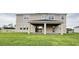 A covered back porch with a manicured yard providing shade and views to the outdoors at 977 Hawksnest Pt, Oviedo, FL 32765