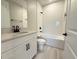 A stylish bathroom features a tub and shower combination with sleek black fixtures and white tiled walls at 977 Hawksnest Pt, Oviedo, FL 32765