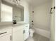 Well-lit bathroom features a vanity, toilet, and shower-tub combination with tiled walls at 977 Hawksnest Pt, Oviedo, FL 32765