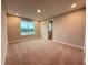 A cozy bedroom with neutral carpeting and a large window offering natural light and views at 977 Hawksnest Pt, Oviedo, FL 32765