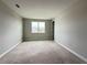An expansive, unfinished bedroom with large windows and neutral walls, awaiting your personalized touch at 977 Hawksnest Pt, Oviedo, FL 32765