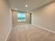 A cozy bedroom with neutral carpeting and a large window offering natural light and views at 977 Hawksnest Pt, Oviedo, FL 32765