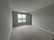 An empty bedroom with a large window offering exterior views at 977 Hawksnest Pt, Oviedo, FL 32765