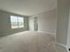 Unfurnished bedroom with neutral walls, trim, and a large window providing natural light at 977 Hawksnest Pt, Oviedo, FL 32765