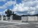 An inviting community entrance featuring stone pillars, a monument sign, and well-maintained landscaping at 977 Hawksnest Pt, Oviedo, FL 32765