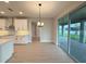 Bright dining area with modern chandelier, tile floors, and sliding glass doors to the outdoor patio at 977 Hawksnest Pt, Oviedo, FL 32765