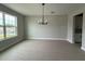 The dining room is bright with a chandelier and tiled floors, creating a lovely dining experience at 977 Hawksnest Pt, Oviedo, FL 32765