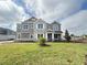 Attractive two-story home featuring stone accents, well-maintained lawn, and recent landscaping at 977 Hawksnest Pt, Oviedo, FL 32765
