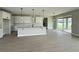 Open-concept kitchen featuring white cabinets, a center island, and sliding glass doors to the backyard at 977 Hawksnest Pt, Oviedo, FL 32765