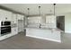 A kitchen features white cabinets, a spacious island, and stainless steel appliances at 977 Hawksnest Pt, Oviedo, FL 32765