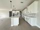 Spacious kitchen with white cabinets, a center island, stainless steel appliances, and open layout at 977 Hawksnest Pt, Oviedo, FL 32765