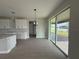 An open concept living area and kitchen features large sliding doors and outdoor access at 977 Hawksnest Pt, Oviedo, FL 32765