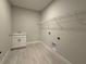 A functional laundry room featuring a utility sink, wire shelving, and tile flooring at 977 Hawksnest Pt, Oviedo, FL 32765