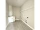 Laundry room features sink, storage, shelving, tile floors, and hookups for washer and dryer at 977 Hawksnest Pt, Oviedo, FL 32765