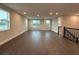 Large living room with dark hardwood floors, recessed lighting, and natural light streaming in at 977 Hawksnest Pt, Oviedo, FL 32765