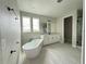Bright bathroom featuring a soaking tub, vanity with modern lighting, and glass enclosed shower at 977 Hawksnest Pt, Oviedo, FL 32765
