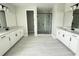 Elegant bathroom with dual vanities, a glass-enclosed shower, and modern fixtures at 977 Hawksnest Pt, Oviedo, FL 32765