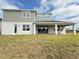 Back exterior of a two-story home featuring an outdoor patio, large windows and a well-maintained lawn at 987 Hawksnest Pt, Oviedo, FL 32765