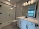 Modern bathroom featuring a glass shower, a sleek vanity, and tile flooring at 987 Hawksnest Pt, Oviedo, FL 32765