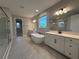 A luxurious bathroom with double vanities, a standalone tub, and a glass-enclosed shower at 987 Hawksnest Pt, Oviedo, FL 32765