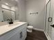 A beautifully designed bathroom with white cabinets, quartz countertop, glass shower, and black finishes at 987 Hawksnest Pt, Oviedo, FL 32765
