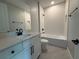 Bright bathroom featuring a modern vanity, shower/tub combo, and tile flooring at 987 Hawksnest Pt, Oviedo, FL 32765