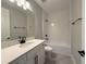 A beautifully designed bathroom with white cabinets, quartz countertop, subway tile, and black finishes at 987 Hawksnest Pt, Oviedo, FL 32765