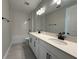 Bright bathroom featuring a double vanity with black hardware and a tub with subway tile surround at 987 Hawksnest Pt, Oviedo, FL 32765