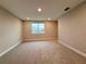 This bedroom features neutral walls, carpet flooring, and a large window letting in natural light at 987 Hawksnest Pt, Oviedo, FL 32765