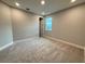 This bedroom features neutral walls, carpet flooring, and a window letting in natural light at 987 Hawksnest Pt, Oviedo, FL 32765