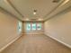 Bright and spacious bedroom featuring three windows offering natural light and neutral carpet flooring at 987 Hawksnest Pt, Oviedo, FL 32765