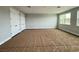 Spacious bedroom with lots of natural light from the windows and a large closet with white doors at 987 Hawksnest Pt, Oviedo, FL 32765