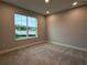 Neutral bedroom with carpet flooring, a large window with a view, and recessed lighting at 987 Hawksnest Pt, Oviedo, FL 32765