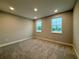 This bedroom features neutral walls, carpet flooring, two windows letting in natural light at 987 Hawksnest Pt, Oviedo, FL 32765