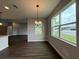 Bright dining room with dark hardwood floors and large windows overlooking the backyard at 987 Hawksnest Pt, Oviedo, FL 32765