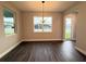 A bright dining room with natural light, wood floors, and views of the outdoors at 987 Hawksnest Pt, Oviedo, FL 32765