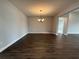 Dining room featuring a modern chandelier, dark hardwood floors, and neutral gray walls at 987 Hawksnest Pt, Oviedo, FL 32765