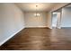 A spacious dining room featuring wood floors, a modern chandelier, and natural light at 987 Hawksnest Pt, Oviedo, FL 32765