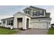 Charming two-story home featuring a stone facade, two-car garage and well maintained landscaping at 987 Hawksnest Pt, Oviedo, FL 32765