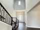 Grand foyer with soaring ceilings, a modern light fixture, and sleek, hardwood-style flooring at 987 Hawksnest Pt, Oviedo, FL 32765