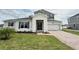 Charming two-story home with manicured lawn, stone accents, and a two-car garage at 987 Hawksnest Pt, Oviedo, FL 32765