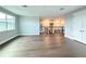 Bright living room with wood-style floors, large window, and staircase access at 987 Hawksnest Pt, Oviedo, FL 32765