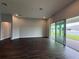 Open-concept living room with dark hardwood floors and sliding glass doors to the patio at 987 Hawksnest Pt, Oviedo, FL 32765