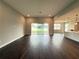 Open-concept living room with dark hardwood floors and sliding glass doors to the backyard at 987 Hawksnest Pt, Oviedo, FL 32765