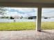View from the covered patio out to a well-manicured lawn and privacy fence at 987 Hawksnest Pt, Oviedo, FL 32765