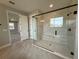 Modern bathroom showcasing a glass-enclosed shower with built-in bench and tiled surround at 987 Hawksnest Pt, Oviedo, FL 32765