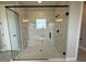Modern bathroom showcasing a glass-enclosed shower with built-in bench and tiled surround at 987 Hawksnest Pt, Oviedo, FL 32765