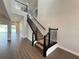 Elegant staircase with dark metal railings and wood treads, leading to the upper level at 987 Hawksnest Pt, Oviedo, FL 32765